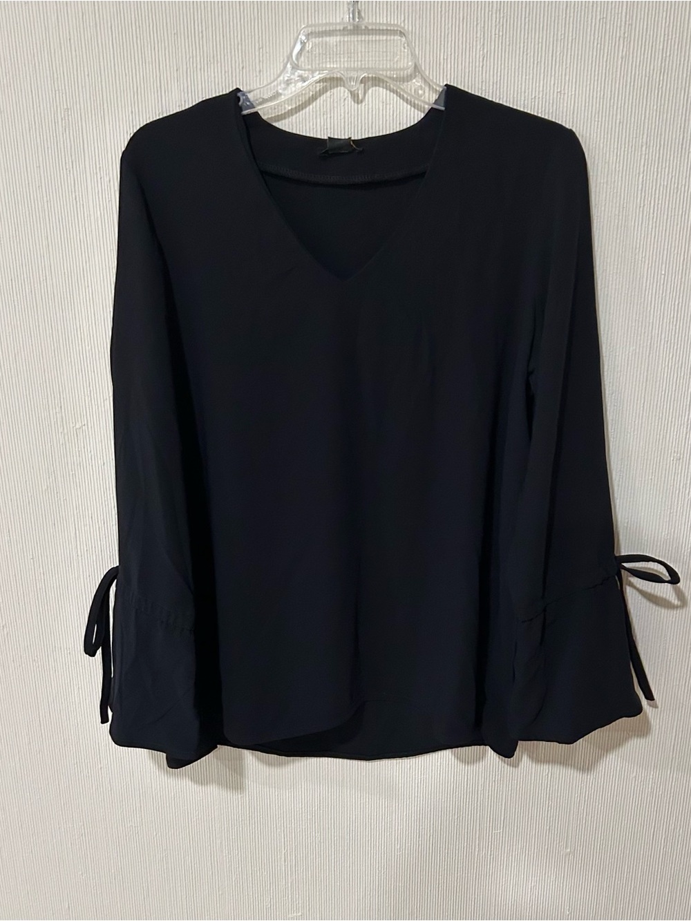 Iman black v-neck long sleeve blouse with tie details on the cuffs in size med